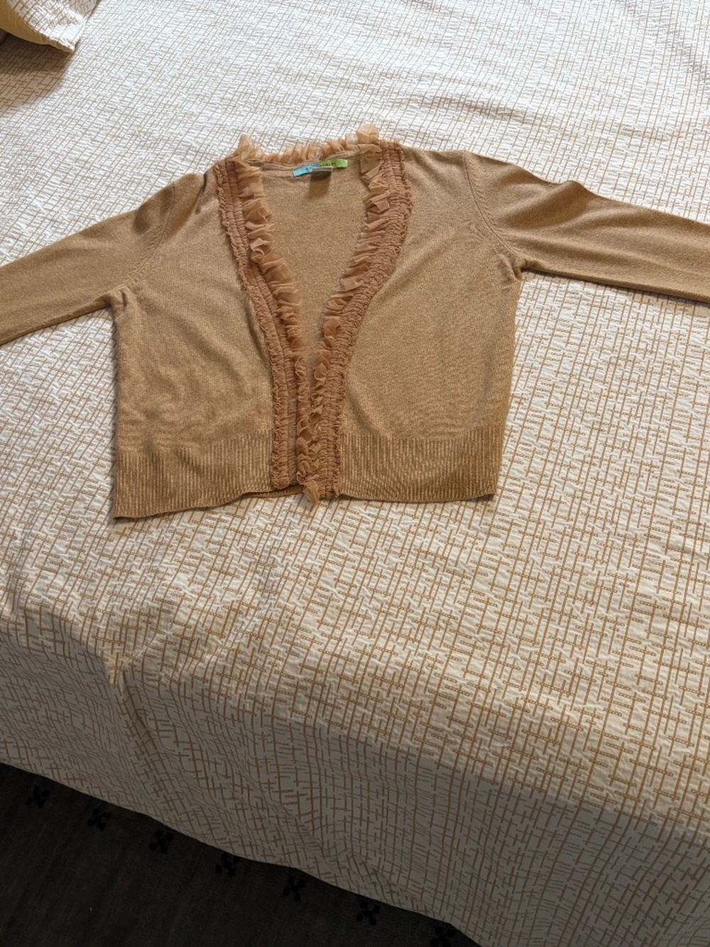 Wool blend cardigan with ruffle sleeves and front.